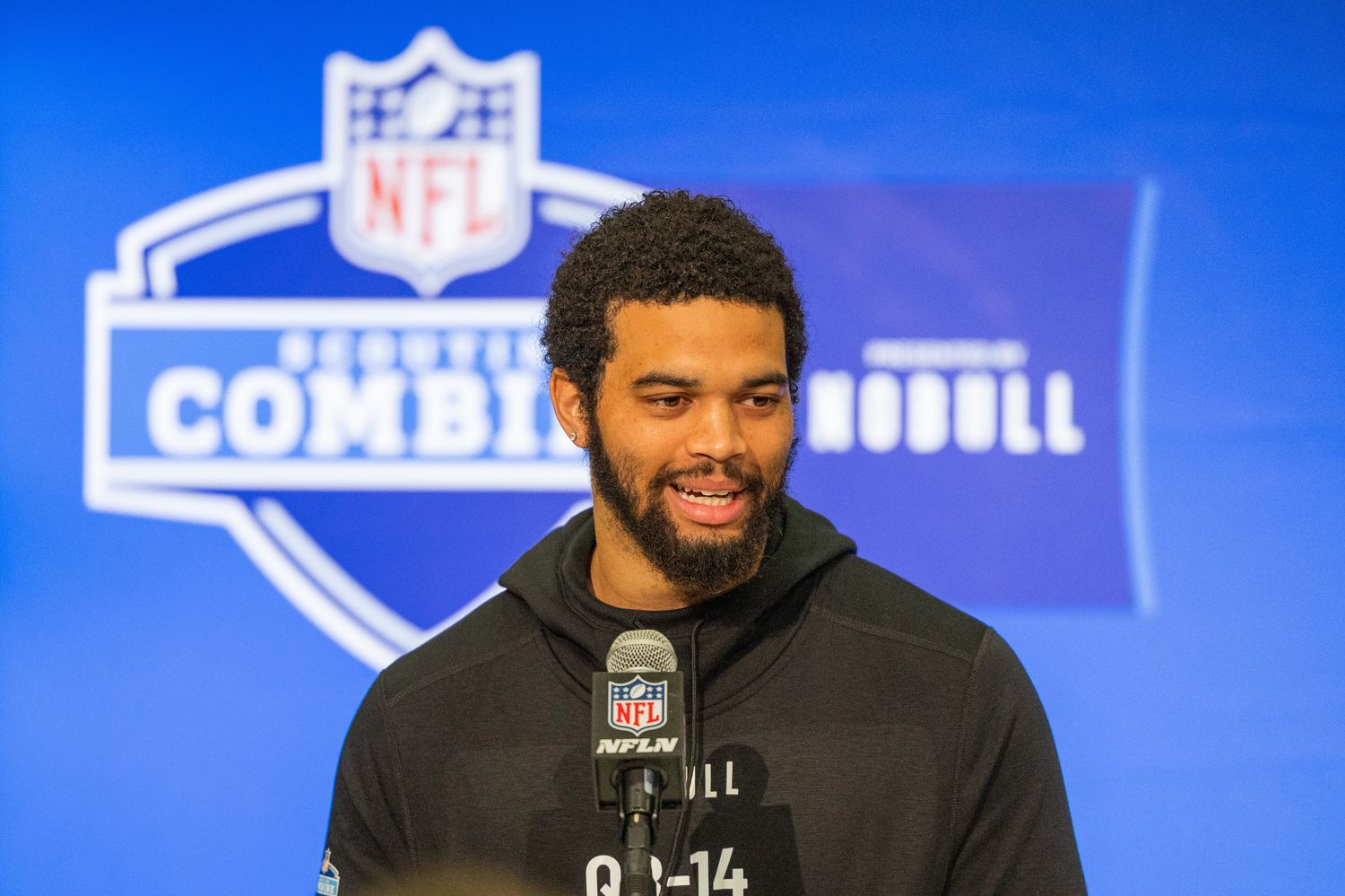 Caption: Mar 1, 2024; Indianapolis, IN, USA; Southern California quarterback Caleb Williams (QB14) talks to the media during the 2024 NFL Combine at Lucas Oil Stadium. Mandatory Credit: Trevor Ruszkowski-USA TODAY Sports